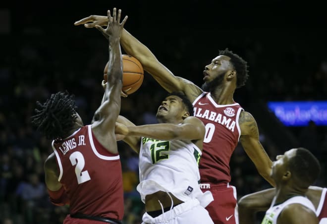 Alabama Crimson Tide guard Kira Lewis Jr. (2) and forward Donta Hall (0) defend Baylor Bears guard Jared Butler (12) under the basket during the second half at Ferrell Center. Photo | USA Today