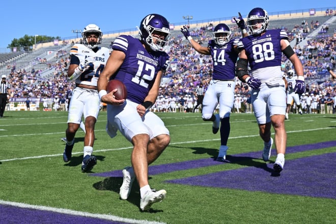 Northwestern QB Jack Lausch celebrates as he scores a touchdown against UTEP. 