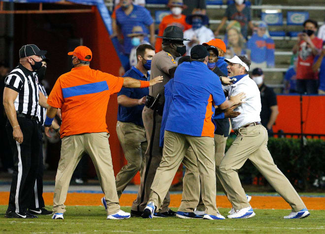 Florida coach Dan Mullen has to be restrained during the brawl at halftime of Missouri's loss at Florida.