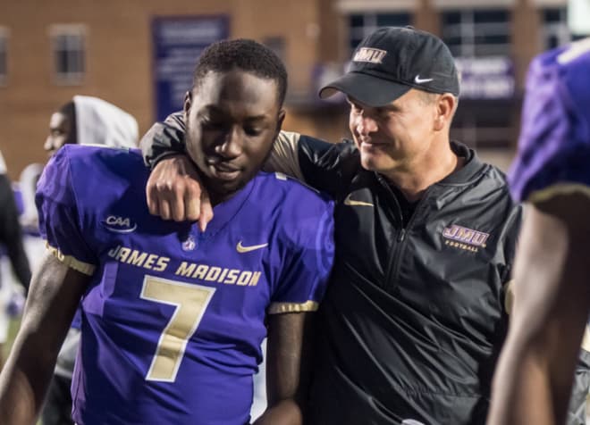 James Madison coach Mike Houston (right) celebrates a win last season with former wide receiver Terrence Alls, who transfered to the school in 2016 after starting his career at Duke.