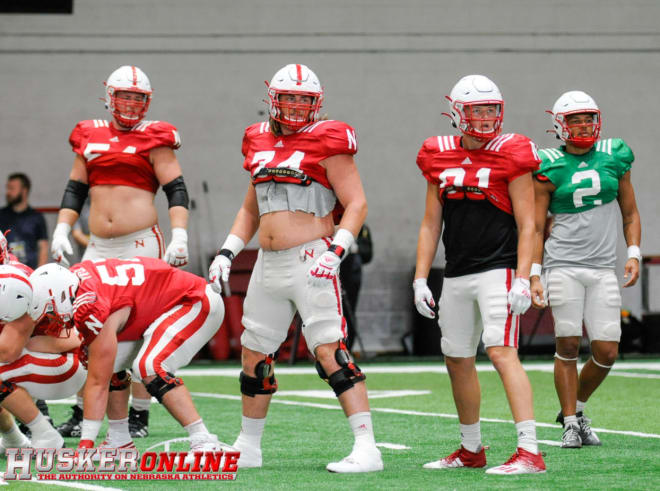 Adrian Martinez, TE James Carnie, RT Brant Banks and LT Bryce Benhart look at Matt Masker on the sideline to get the play signal in practice