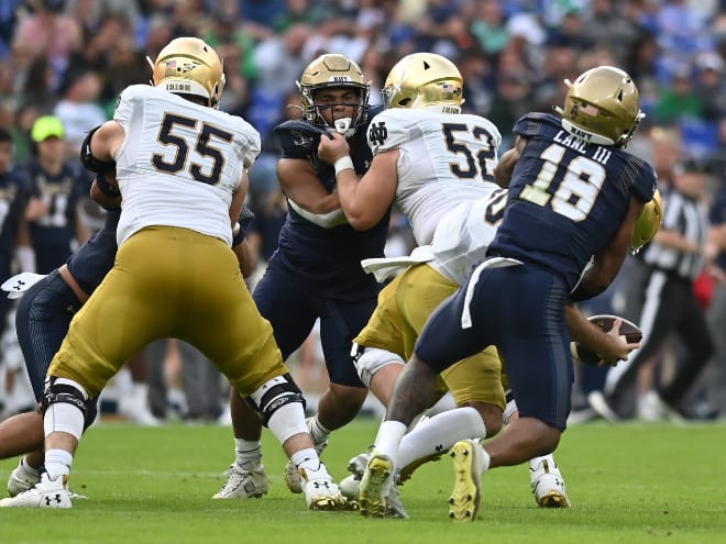 Navy safety Rayuan Lane III sacks Notre Dame quarterback Drew Pyne.