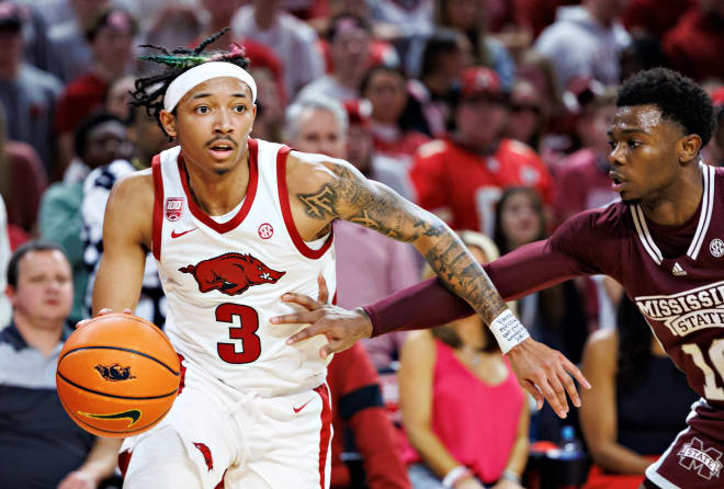 Nick Smith Jr. #3 of the Arkansas Razorbacks drives to the basket against Dashawn Davis #10 of the Mississippi State Bulldogs at Bud Walton Arena on February 11, 2023 in Fayetteville, Arkansas. The Bulldogs defeated the Razorbacks 70-64. 