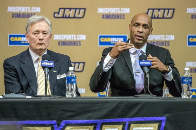 James Madison athletic director Jeff Bourne, left, introduces Louis Rowe as the Dukes' men's basketball coach during a 2016 press conference.
