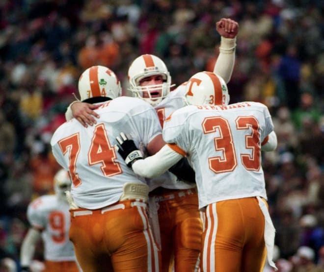 Tennessee quarterback Heath Shuler, center, celebrates a big play in leading the Vols comeback in the fourth quarter against hosted Vanderbilt with teammates guard Jeff Smith (74) and running back James Stewart (33) at Dudley Field in Nashville Nov. 28, 1992. The 18th ranked Tennessee gave head coach Johnny Majors a 29-25 victory in his final regular game.