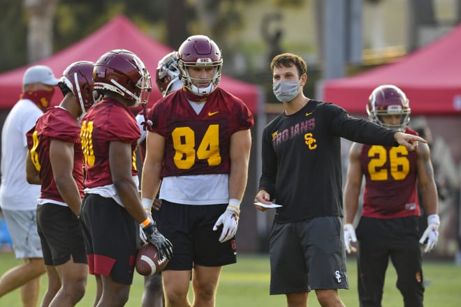 Offensive coordinator Graham Harrell instructs his guys on Friday.