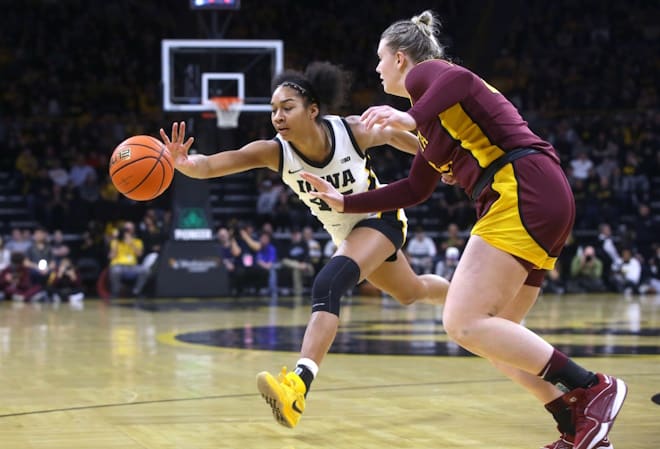 Iowa's Hannah Stuelke (45) reaches for the basketball against Minnesota Saturday, Dec. 30, 2023 at Carver-Hawkeye Arena.