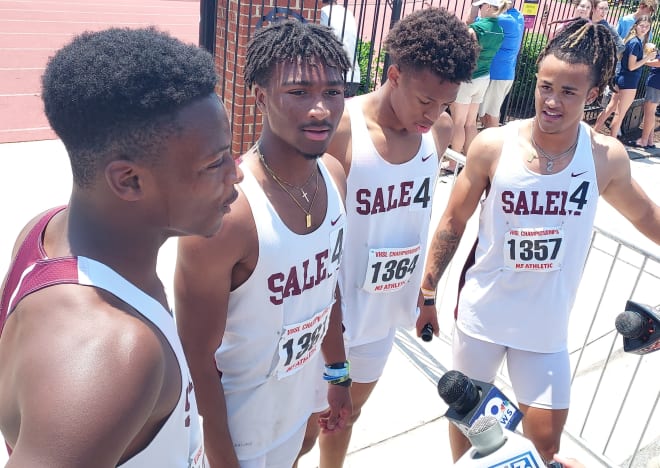 Salem's Peyton Lewis (far right) joins with teammates Jonathan Vernon, Josiah Persinger, and DaRon Wilson discussing their 4 x 100 meter win at the Class 4 State Meet June 3.
