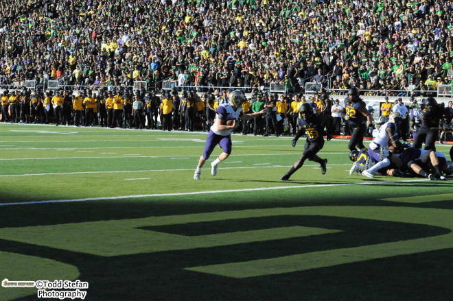 Jake Browning points toward an Oregon defender before scoring Washington's first touchdown. 