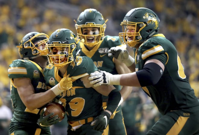 North Dakota State wide receiver Jimmy Kepouros (19) celebrates with teammates after scoring a touchdown during the Bison's win over Montana State in the semifinals of the FCS playoffs last month at the FargoDome in Fargo, N.D.
