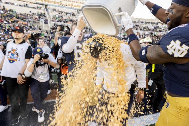 Notre Dame coach Marcus Freeman gets a bath of Frosted Flakes as part of the celebration of his team's 40-8 victory in the Tony the Tiger Sun Bowl.
