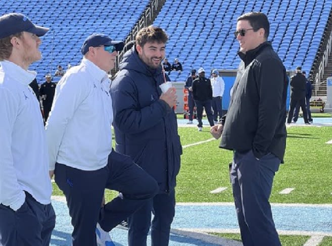 Sam Howell (middle) hung out chatting before watching his teammates beat Wofford on Saturday.