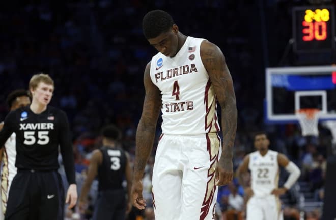 Florida State star sophomore swingman Dwayne Bacon walks dejectedly off the court in his team's 91-66 loss to Xavier on Saturday.