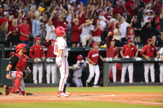 Charlie Welch admires his three-run home run that essentially iced Arkansas' win over Nebraska on Monday.