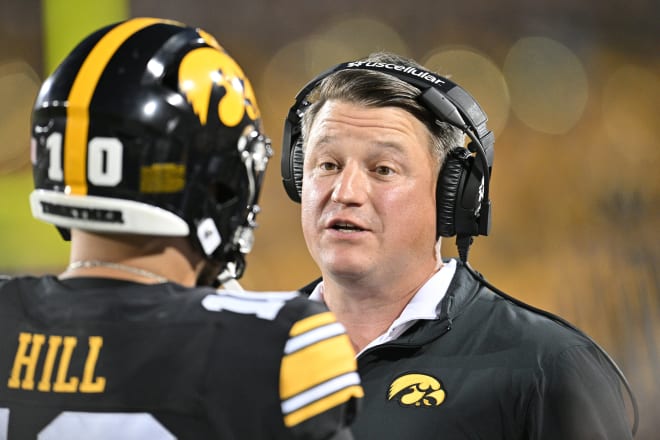 Brian Ferentz talks with quarterback Deacon Hill during the first quarter against the Michigan State Spartans. Mandatory Credit: Jeffrey Becker-USA TODAY Sports