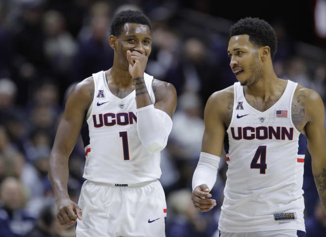 UConn guards Christian Vital (1) and guard Jalen Adams (4) 