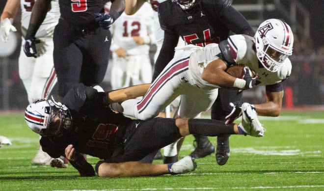 Zavier Hamilton (ball carrier) dives forward for extra yardage in a game on September 10, 2021.