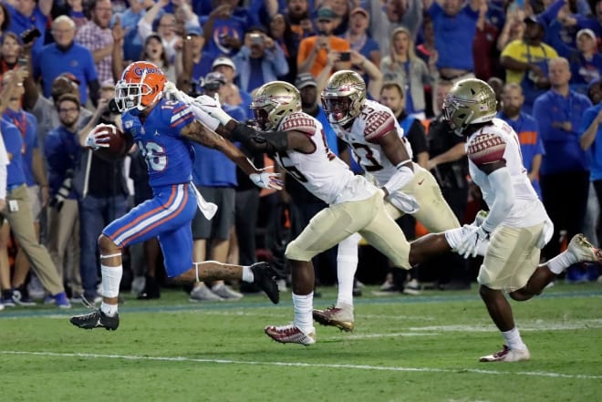 UF receiver Freddie Swain races into the end zone for one of his two first-half touchdowns Saturday.