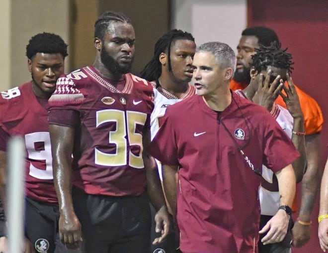 FSU coach Mike Norvell encourages linebacker Leonard Warner during a 'Tour of Duty' conditioning drill in February.