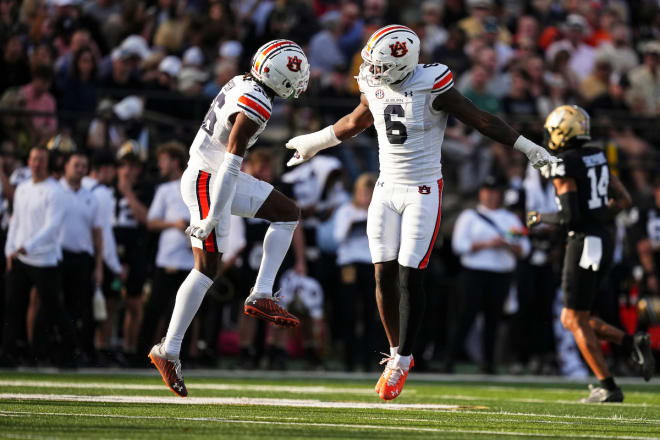 Jaylin Simpson and Keys celebrate a big play by Auburn's defense.