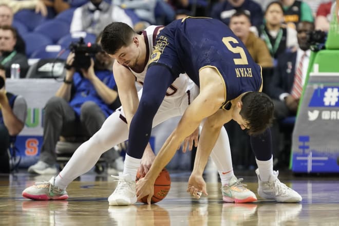 Virginia Tech guard Hunter Cattoor (0) gets his hands on the ball as Notre Dame guard Cormac Ryan (5) fights for possession in Tuesday night's Irish ACC Tournament loss in Greensboro, N.C.