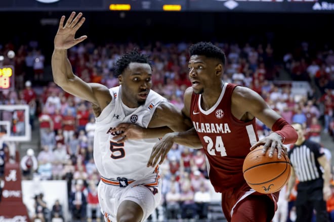 Alabama Crimson Tide forward Brandon Miller (24) drives the lane around Auburn Tigers forward Chris Moore (5) during the second half of an NCAA basketball game at Coleman Coliseum. Photo | Butch Dill-USA TODAY Sports
