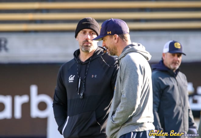 Defensive coordinator Peter Sirmon (left) and Cal head coach Justin Wilcox talk before a practice in the spring.