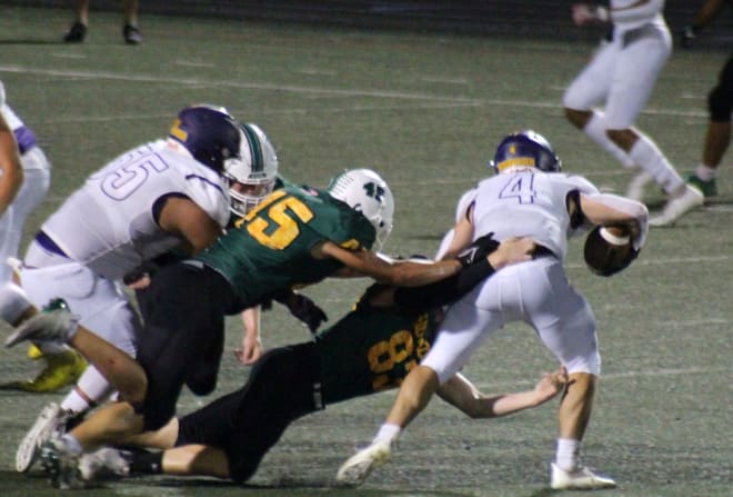 Cody Naughton (right) and Nicholas Harris (left) close in on a Sunrise Mountain ball carrier.  In two games, Horizon's defense is limiting opponents to 68 rushing yards per game.
