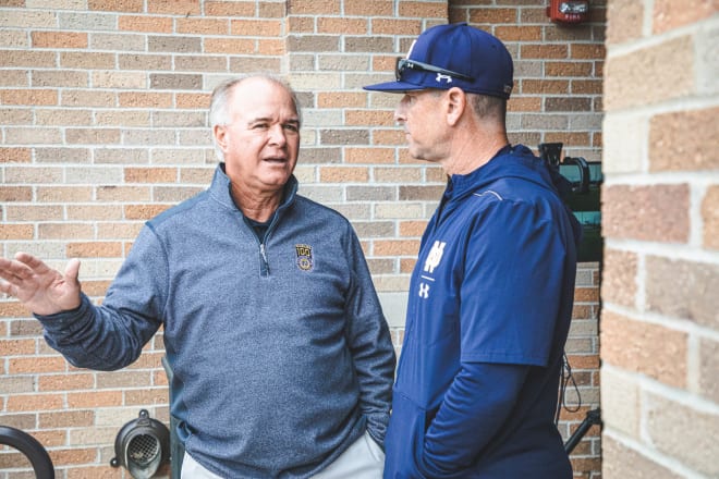 Former Notre Dame head coaches Paul Mainieri and Link Jarrett chat before an Irish baseball game this past season.