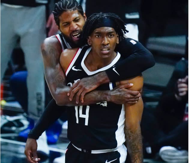 L.A. Clippers superstar Paul George hugs Terance Mann during his 39-point outburst Friday night in the NBA's Western Conference semifinals.
