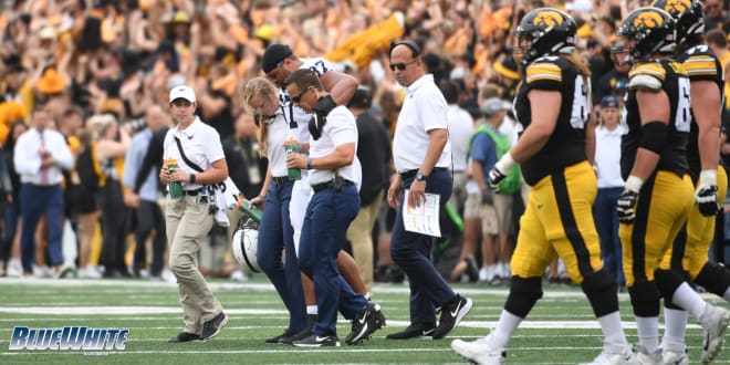 Penn State Nittany Lions football senior DT P.J. Mustipher was helped off the field at Kinnick Stadium.
