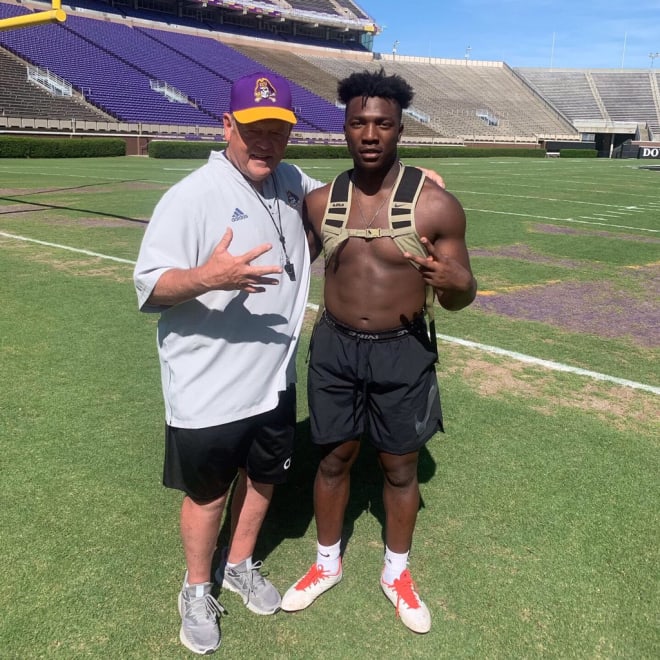 Cortezz Jones pictured with ECU defensive line coach Jeff Hanson on Saturday in Dowdy-Ficklen Stadium.