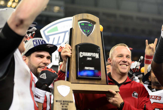 Then Northern Illinois Huskies coach Dave Doeren holds the championship trophy after defeating Kent State Golden Flashes 44-37 in double overtime to win the 2012 MAC Championship at Ford Field in Detroit, Mich.