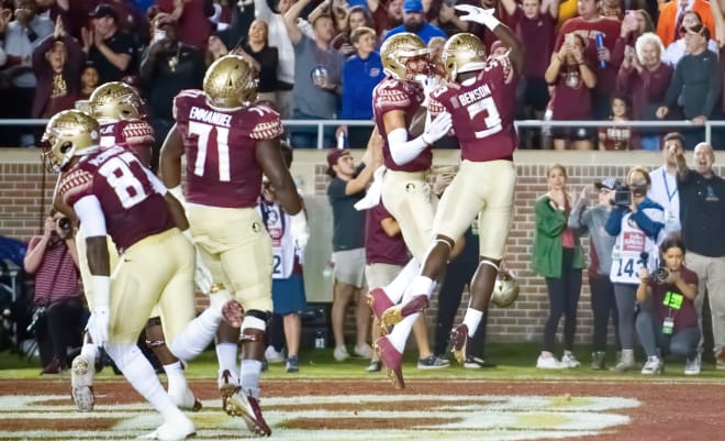 Trey Benson and Johnny Wilson celebrate a touchdown in Friday's win.