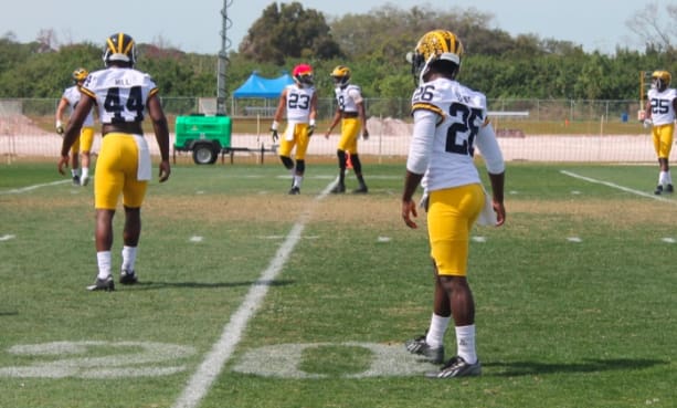 Defensive backs Delano Hill and Jourdan Lewis (fore), Tyree Kinnel and Channing Stribling (back)