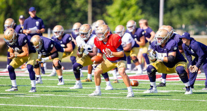 Notre Dame fifth-year senior quarterback Ian Book with his teammates at a practice