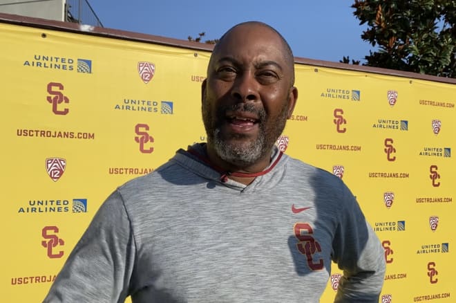 USC running backs coach Mike Jinks talking to reporters after practice Thursday.