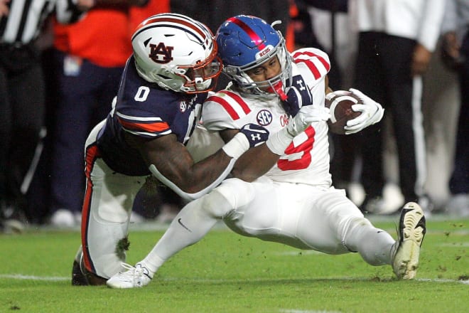 Owen Pappoe makes a tackle against Ole Miss.