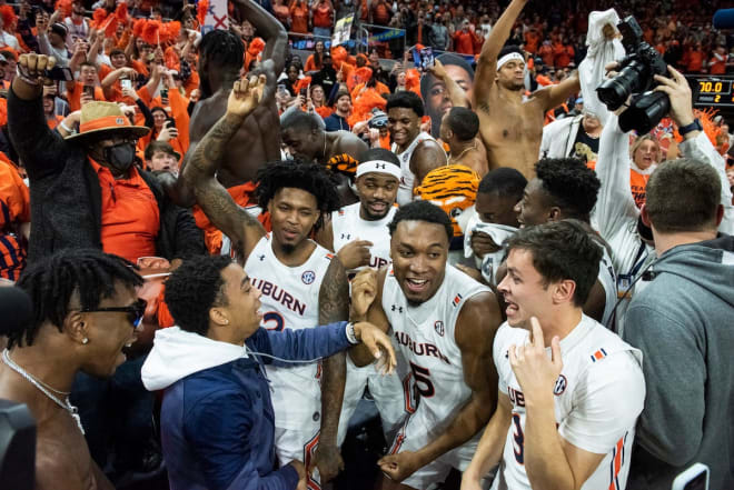 Auburn players celebrate with the student section following Saturday's victory.