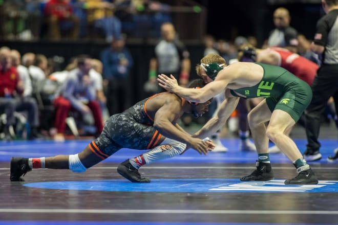 Princeton wrestler Quincy Monday (left) wrestles Michigan State wrestler Caleb Fish in a 165 pound weight class quarterfinal during the NCAA Wrestling Championships at the BOK Center.