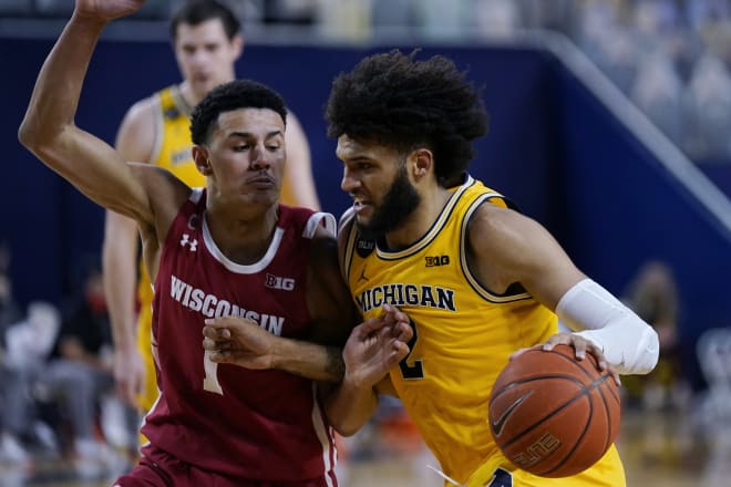 Michigan forward Isaiah Livers (2) drives on Wisconsin guard Jonathan Davis (1) during the Wolverines' 77-54 victory over Wisconsin.