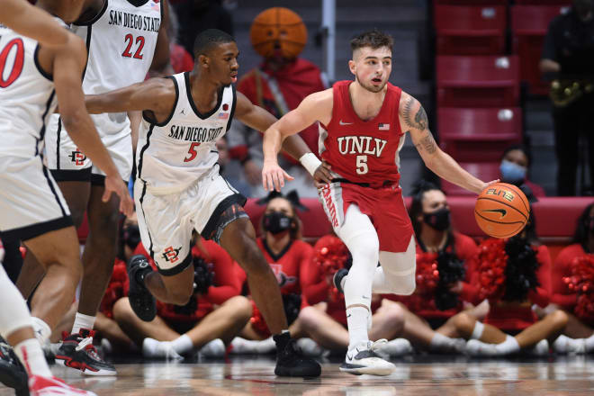 UNLV Rebels guard Jordan McCabe (5) dribbles the ball while defended by San Diego State Aztecs guard Lamont Butler (5) during the second half at Viejas Arena.