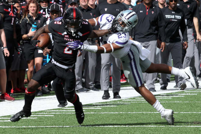 Texas Tech Red Raiders wide receiver Keke Coutee (2) stiff arms Kansas State Wildcats defensive back Cre Moore (23) at Jones AT&T Stadium.