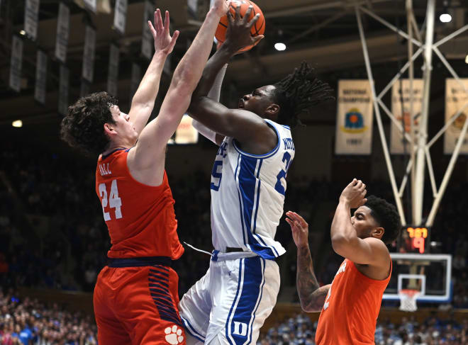 Mark Mitchell shoots against PJ Hall, left, during Saturday's game. 