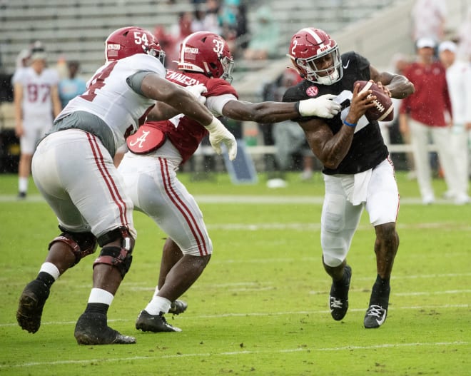 Crimson linebacker Demouy Kennedy (37) tags down White quarterback Jalen Milroe (2) during the A-Day game at Bryant-Denny Stadium. Photo | Gary Cosby Jr.-USA TODAY Sports