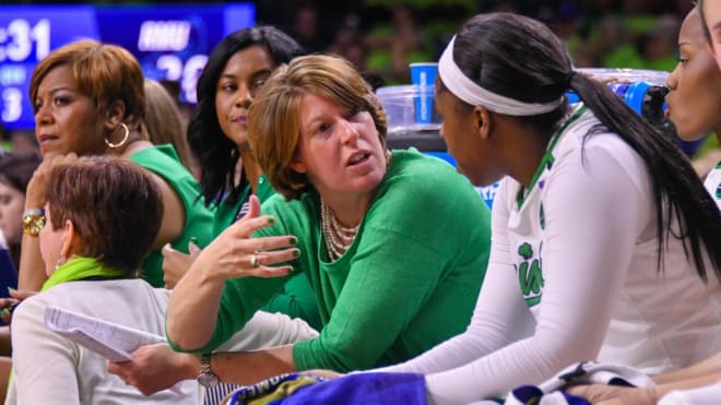 Former Notre Dame player and assistant coach Beth (Morgan) Cunningham gives instruction to Arike Ogunbowale during a game