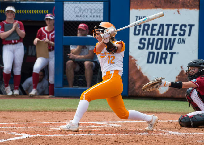 Oklahoma City, OK, USA; Tennessee Lady Vols shortstop Mackenzie Donihoo (12) hits a grounder in the second inning against the Alabama Crimson Tide during the Womens College World Series at USA Softball Hall of Fame Stadium. Mandatory Credit: Brett Rojo-USA TODAY Sports