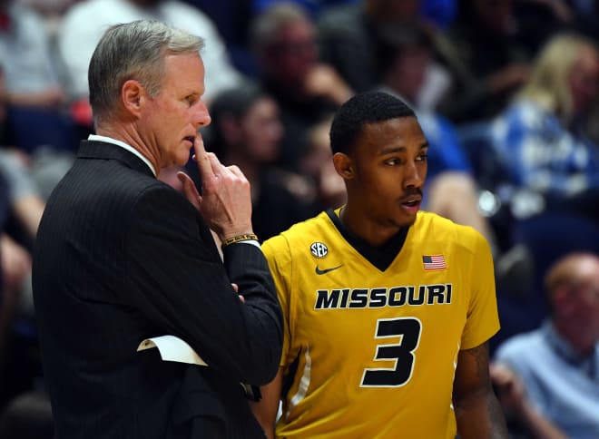 Kim Anderson talks with Frankie Hughes during his final game as Missouri's coach