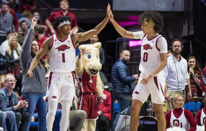 Arkansas' Ricky Council IV (left) and Anthony Black (right) high five during a win over Oklahoma on Dec. 10. 