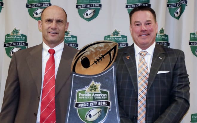 The coaches in last season's Music City Bowl — Nebraska's Mike Riley (left) and Tennessee's Butch Jones — have been fired by their respective schools. 